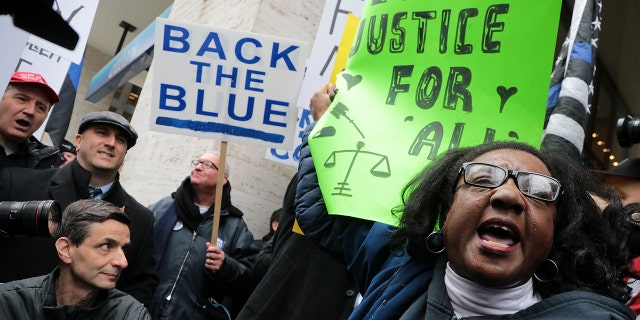 April 1, 2019 - Chicago, Illinois, U.S. - Dueling protests from the Fraternal Order of Police, left, and Chicago Alliance Against Racist and Political Repression, right, take place outside the Cook County Administration Building in response to the ongoing controversy over the Smollett case. (Credit Image: © Antonio Perez/Chicago Tribune/TNS via ZUMA Wire)