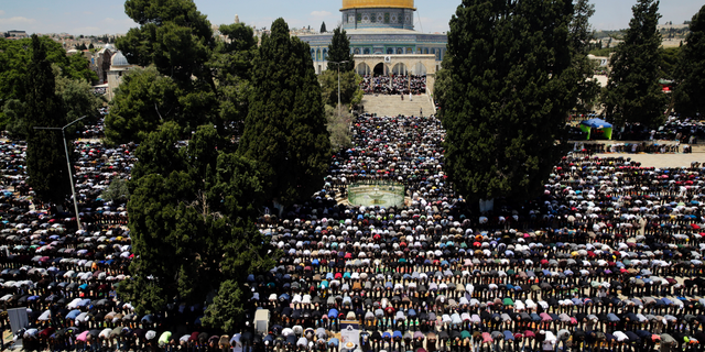 Palestinians pray in front of the Dome of the Rock shrine during a holy month of Ramadan, in Jerusalem, Friday, May 10, 2019. (AP Photo/Mahmoud Illean)