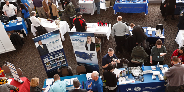 FILE - In this March 7, 2019, photo visitors to the Pittsburgh veterans job fair meet with recruiters at Heinz Field in Pittsburgh. On Friday, May 3, the U.S. government issues the April jobs report. (AP Photo/Keith Srakocic, File)