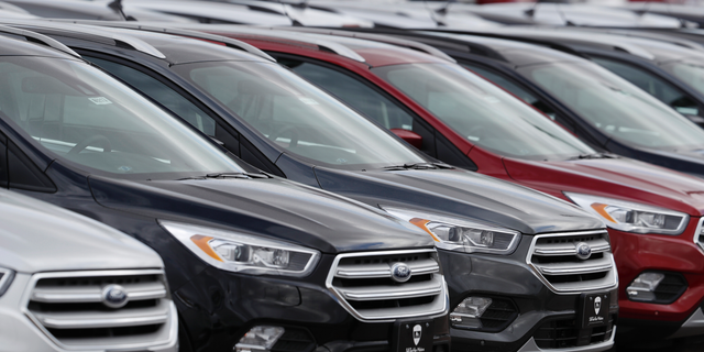 FILE- In this Feb. 17, 2019, file photo rows of unsold 2019 Escape sports-utility vehicles sit in long rows at a Ford dealership in Broomfield, Colo. On Wednesday, May 15, the Commerce Department releases U.S. retail sales data for April. (AP Photo/David Zalubowski, File)