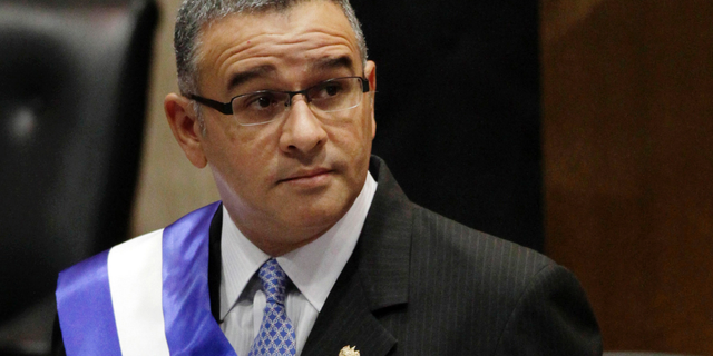 FILE - In this June 1, 2012 file photo, El Salvador's President Mauricio Funes stands in the National Assembly before speaking to commemorate the anniversary of his third year in office in San Salvador, El Salvador. Funes, who is a fugitive of El Salvador’s courts and lives under political asylum in Nicaragua, said Monday, May 13, 2019, that he is working as an adviser to the government of Nicaraguan President Daniel Ortega. (AP Photo/Luis Romero, File)