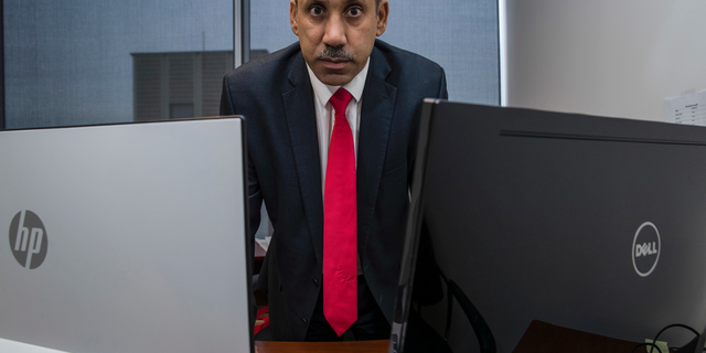FILE - In this Oct. 26, 2018, file photo Ali AlAhmed poses for a photograph in his office in Washington. Citizen Lab says a fake Twitter account unmasked by The Associated Press was but one piece of a vast years-old and multi-lingual campaign aimed at seeding anti-Saudi, anti-Israel and anti-American stories across the internet. The Associated Press was on the verge of publishing a story about how AlAhmed, who is based in the Washington area, had been targeted by hackers posing as a female journalist. (AP Photo/Alex Brandon, File)