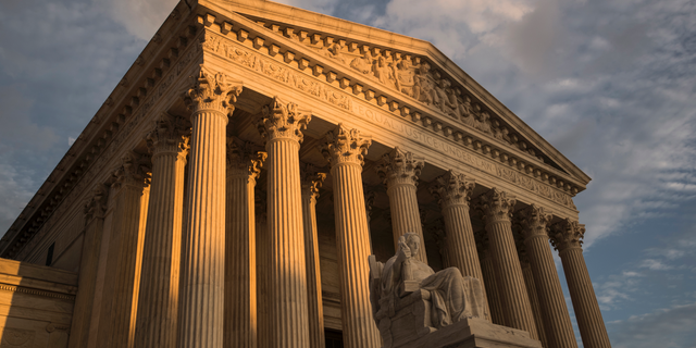 FILE - In this Oct. 10, 2017, file photo, the Supreme Court in Washington, at sunset. The Justice Department’s ability to charge minors for supporting terrorist groups has been hampered by a 2018 Supreme Court decision, forcing prosecutors to hand off at least one such case to local authorities in a state without anti-terrorism laws. (AP Photo/J. Scott Applewhite, File)
