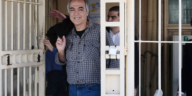 FILE - In this Thursday, Nov. 9, 2017 file photo, Dimitris Koufodinas smiles as he leaves Korydallos prison in western Athens. A Greek far-left extremist serving 11 life terms for a string of murders is vowing to continue "until the end" with a hunger strike after judges rejected his bid for new leave from prison. A lawyer representing Koufodinas, chief hit man for the November 17 group that killed 23 people from 1975-2000, says her client will also refuse medical assistance. (Yannis Kotsiaris/InTime News via AP, file)