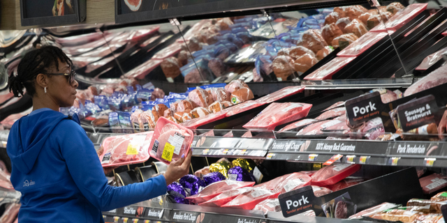 FILE - In this April 24, 2019 file photo,  a customer shops at the meat counter at a Walmart Neighborhood Market in Levittown, N.Y. On Friday, May 10, the Labor Department reports on U.S. consumer prices for March. (AP Photo/Mark Lennihan, File)
