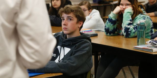 High school freshmen listen to Wexford County prosecutor Jason Elmore talk about consent and criminal sexual conduct on Wednesday, April 17, 2019, in Cadillac, Mich. Among other things, he reminded them that the legal age of consent for sexual contact in the state of Michigan is 16. Most of the students in these classes are younger than that. (AP Photo/Martha Irvine)