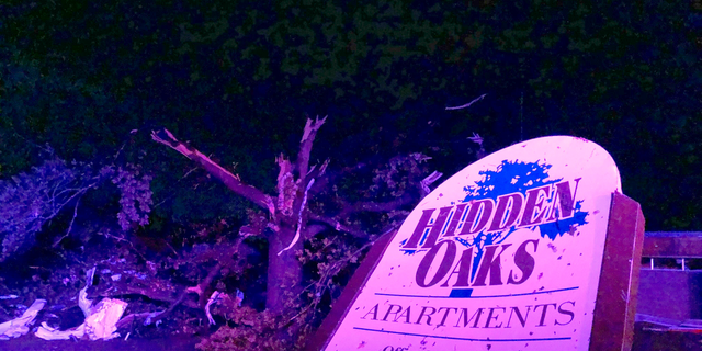 The sign for the Hidden Oaks apartment complex in Jefferson City Missouri stands bent after a violent tornado touched down.