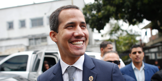 Opposition leader Juan Guaidó smiles at supporters as he arrives for a press conference in Caracas, Venezuela, Friday, May 3, 2019. 