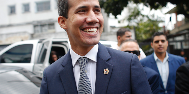 Opposition leader Juan Guaidó smiles at supporters as he arrives for a press conference in Caracas, Venezuela, Friday, May 3, 2019.