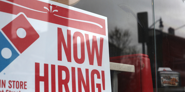 In this April 14, 2019, photo a now hiring sign is posted at a Domino's Pizza in Jersey City, N.J. AP Photo/Jenny Kane)