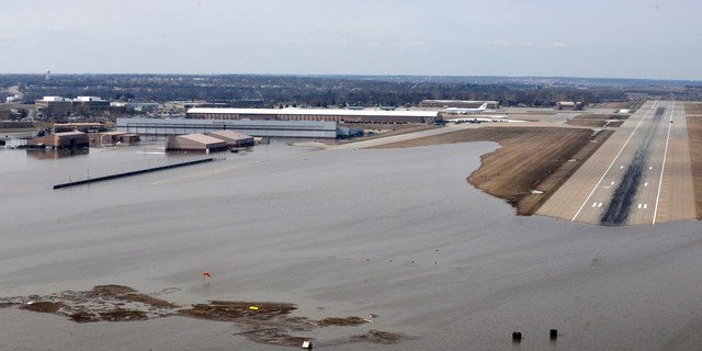 FILE - This March 17, 2019, file photo provided by the U.S. Air Force shows an aerial view of Offutt Air Force Base and the surrounding areas affected by floodwaters in Nebraska. The Air Force is raising its cost estimate to $420 million to repair and replace structures damaged at the Nebraska base following severe flooding that inundated buildings with water. (Tech. Sgt. Rachelle Blake/U.S. Air Force via AP, File)