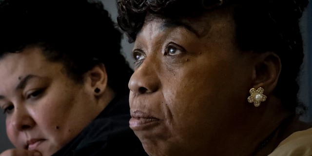 In this Wednesday May 8, 2019, photo, Loyda Colon, left, co-Director of the Justice Committee, listens while Gwen Carr, right, mother of Eric Garner, an unarmed black man who died as he was being subdued in a chokehold by NYPD police officer Daniel Pantaleo nearly five years ago, speaks during an interview, Wednesday May 8, 2019, in New York. A New York City judge has cleared the way for a police disciplinary trial to begin next week for Pantaleo in the death of her son, after rejecting his claim that a police watchdog agency didn't have jurisdiction to prosecute the case. (AP Photo/Bebeto Matthews)