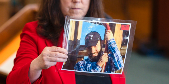 Prosecutor Susan Hardin shows a picture of Steven Bourgoin as he appeared in 2016 during his murder trial in Vermont Superior Court in Burlington on Monday, May 6, 2019. Bourgoin is facing five counts of second-degree murder for a crash that killed five teenagers on I-89 in Williston in 2016. (Glenn Russell/The Burlington Free Press via AP, Pool)