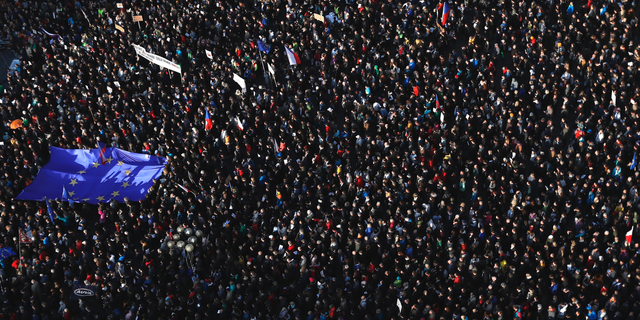 Protesters gather at the Old Town Square in Prague, Czech Republic, Monday, May 6, 2019. Thousands of Czechs rallied in Prague for the second time in a week to demand the resignation of the new justice minister. The protesters say the minister might compromise the legal system at a time when prosecutors have to decide whether to indict Prime Minister Andrej Babis over alleged fraud involving European Union funds. Babis denies wrongdoing. (AP Photo/Petr David Josek)