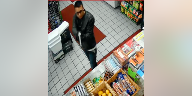 FILE - This Tuesday, May 7, 2019, file photo taken from surveillance video, released by the Downey, Calif., Police Department, shows the suspect in the murder of a Downey, Calif., liquor store owner as authorities sought the public's help in identifying him. Police say a man wounded in a car chase shootout in Southern California Friday, May 10, is suspected of killing a liquor store owner days earlier. The man was dragged unmoving from the car on Friday afternoon after a chase that began in Downey. (Downey Police Department via AP)