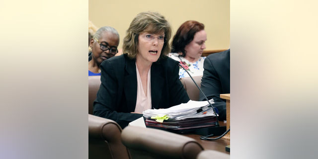 FILE - In this June 14, 2018 file photo, Arkansas Department of Correction Director Wendy Kelley testifies before legislators at the state Capitol in Little Rock, Ark. A federal trial over Arkansas' use of a sedative in lethal injections is wrapping up in Little Rock following testimony from the state's prisons director. Kelley testified Wednesday, May 1, 2019, about her role overseeing four executions that occurred over a two-week span in 2017. (AP Photo/Kelly P. Kissel, File)