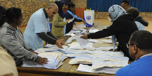 In this photo taken Wednesday, May 8, 2019, vote counting begins at a polling station in Cape Town, South Africa. Vote counting continued Thursday May 9, 2019 after South Africans voted Wednesday in a national election that pits President Cyril Ramaphosa's ruling African National Congress against top opposition parties Democratic Alliance and Economic Freedom Fighters, 25 years after the end of apartheid. (AP Photo/Nasief Manie)