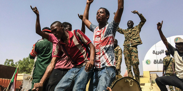 FILE - In this April 11, 2019 file photo, Sudanese celebrate after officials said the military had forced longtime autocratic President Omar al-Bashir to step down after 30 years in power in Khartoum, Sudan. As the uprising against Sudanese President Omar al-Bashir gained strength, Egypt, the United Arab Emirates and Saudi Arabia began reaching out to the military through secret channels to encourage his removal from power. They had long viewed al-Bashir as a problem because of his close ties to Islamists. (AP Photo, File)