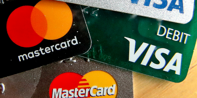 In this Feb. 20, 2019, logos for credit cards are visible on the cards in Zelienople, Pa. On Tuesday, May 7, the Federal Reserve releases its March report on consumer borrowing. (AP Photo/Keith Srakocic)