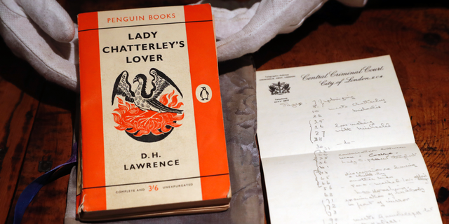FILE - In this Friday, Oct. 26, 2018 file photo, a copy of D.H Lawrence's book "Lady Chatterley's Lover" that was the judge's personal version used in the infamous 1960 Chatterley trial, on view in Sotheby's auction house in London. The British government has on Monday, May 13, 2019 used its powers to preserve the nation’s cultural treasures to halt the export of a tattered paperback copy of “Lady Chatterley’s Lover.” The copy of the once-scandalous book was used by the judge in the U.K. obscenity trial of Penguin Books, prosecuted in 1960 for publishing D.H. Lawrence's novel about an affair between a wealthy woman and her husband's gamekeeper.(AP Photo/Alastair Grant, File)