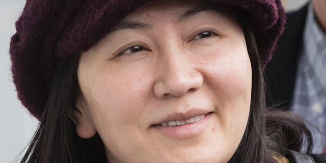 FILE _ in this March 6, 2019, file photo, Huawei chief financial officer Meng Wanzhou arrives back at her home after a court appearance in Vancouver, British Columbia. China has formally arrested two Canadian citizens it is believed to be holding to pressure Canada into releasing Meng Wanzhou. (Darryl Dyck/The Canadian Press via AP, File )