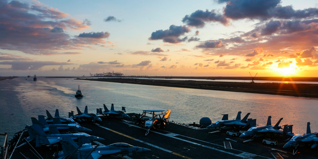 In this Thursday, May 9, 2019 photo released by the U.S. Navy, the Nimitz-class aircraft carrier USS Abraham Lincoln transits the Suez Canal in Egypt. The aircraft carrier and its strike group are deploying to the Persian Gulf on orders from the White House to respond to an unspecified threat from Iran. (Mass Communication Specialist Seaman Dan Snow, U.S. Navy via AP)