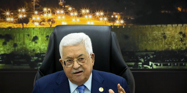 FILE - In this April 29, 2019, file photo, Palestinian President Mahmoud Abbas, center, chairs a session of the weekly cabinet meeting in the West Bank city of Ramallah. The Trump administration will unveil the first phase of its long-awaited blueprint for Mideast peace next month at a conference in the region designed to highlight economic benefits that could be reaped if the Israeli-Palestinian conflict is resolved, the White House said Sunday, May 19. Jared Kushner and Jason Greenblatt, envoy of international negotiations, have been leading efforts to write the plan, but so far, there's been no participation from the Palestinians. (AP Photo/Majdi Mohammed, Pool, File)
