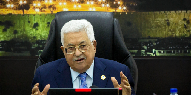 FILE - In this April 29, 2019, file photo, Palestinian President Mahmoud Abbas, center, chairs a session of the weekly cabinet meeting in the West Bank city of Ramallah. The Trump administration will unveil the first phase of its long-awaited blueprint for Mideast peace next month at a conference in the region designed to highlight economic benefits that could be reaped if the Israeli-Palestinian conflict is resolved, the White House said Sunday, May 19. Jared Kushner and Jason Greenblatt, envoy of international negotiations, have been leading efforts to write the plan, but so far, there's been no participation from the Palestinians. (AP Photo/Majdi Mohammed, Pool, File)