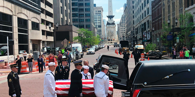 A military honor guard loads the casket of former Sen. Richard Lugar into a hearse outside the Indiana Statehouse Wednesday, May 15, 2019, in Indianapolis for the procession to his funeral. The procession is taking the casket through the streets of Indianapolis on the way to his funeral. The procession paused at the Indianapolis City-County Building beneath a large garrison flag in recognition of his time as the city's mayor before his first election to the Senate in 1976. (AP Photo/Tom Davies)
