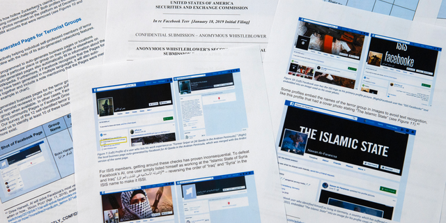 Pages from a confidential whistleblower's report obtained by The Associated Press are photographed Tuesday, May 7, 2019, in Washington. Facebook likes to give the impression that it’s stopping the vast majority of extremist posts before users ever see them., but the confidential whistleblower’s complaint to the Securities and Exchange Commission alleges the social media company has exaggerated its success. Even worse, it shows that the company is making use of propaganda by militant groups to auto-generate videos and pages that could be used for networking by extremists. (AP Photo/Jon Elswick)