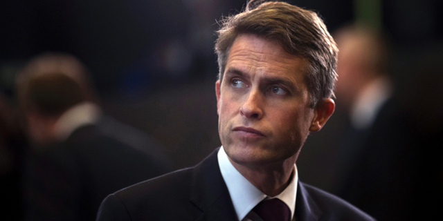 FILE - In this Thursday, Oct. 4, 2018 file photo, Britain's Defence Minister Gavin Williamson stands in the main chamber during a gathering of NATO defence ministers at NATO headquarters in Brussels. British Defense Secretary Gavin Williamson has been fired Wednesday, May 1, 2019 after an investigation into leaks from a secret government meeting about Chinese telecoms firm Huawei. Prime Minister Theresa May's office says May has "lost confidence" in Williamson. (AP Photo/Francisco Seco, file)
