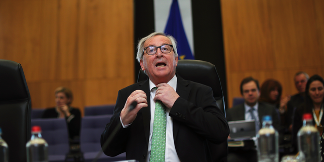 European Commission President Jean-Claude Juncker adjusts his tie prior a College of Commissioners meeting at the European Commission headquarters in Brussels, Tuesday, May 7, 2019. (AP Photo/Francisco Seco)