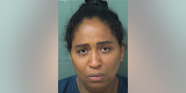 This May 9, 2019 photo made available by the Palm Beach County Sherif's Office shows Rafaelle Sousa under arrest. Sousa is charged with attempted murder and child abuse after she delivered a baby girl, put her in a plastic bag and tossed her into a dumpster. The baby was found alive. (Palm Beach County Sheriff's Office via AP)