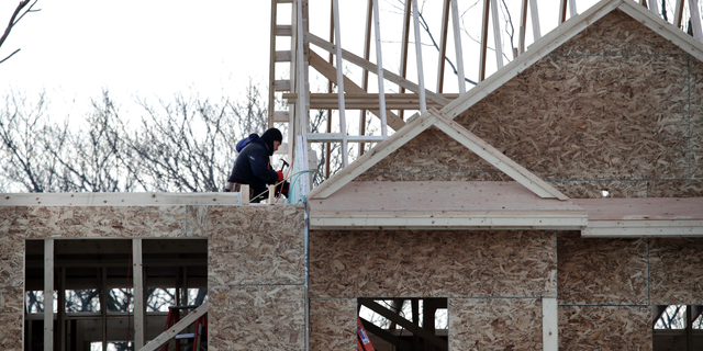 FILE - In this Jan. 23, 2019, file photo, construction workers build new housing in Salisbury, Mass. On Thursday, May 16, the Commerce Department reports on U.S. home construction in April. (AP Photo/Elise Amendola, File)