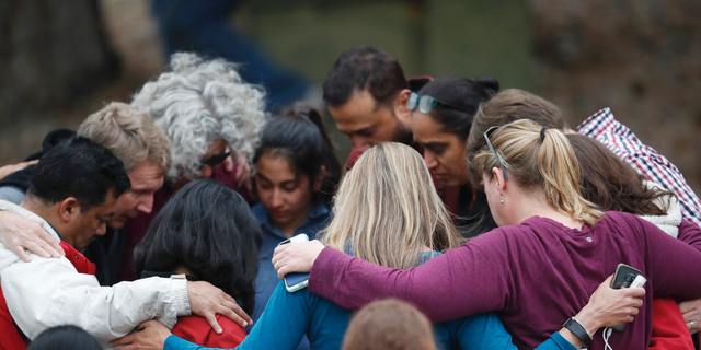 Parents gather in a circle to pray at a recreation center where students were reunited with their parents after a shooting at a suburban Denver middle school Tuesday, May 7, 2019, in Highlands Ranch, Colo. (AP Photo/David Zalubowski)