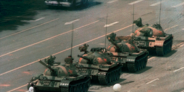 In this June 5, 1989 file photo, a Chinese man stands alone to block a line of tanks heading east on Beijing's Changan Blvd. in Tiananmen Square. (AP Photo/Jeff Widener, File )