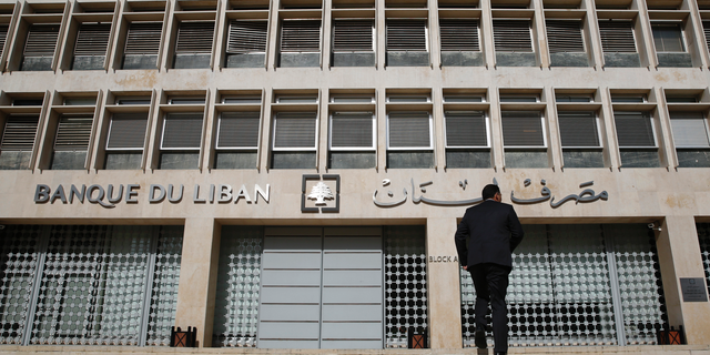 FILE - This Tuesday, Jan. 22, 2019 file photo, a man heads to the Lebanese central bank, in Beirut, Lebanon. The Beirut Stock Exchange said Monday, May 6, 2019, that it is suspending trading due to the open strike declared by the employees of Lebanon's central bank. Hundreds of Lebanese public employees are on strike amid concerns that their salaries and benefits might be cut as the government discusses an austerity budget. (AP Photo/Hussein Malla, File)