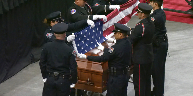 FILE - In this Aug. 17, 2018, file photo, members of an honor guard fold the U.S. flag during flag presentation at the funeral services for Jill Robinson, in West Valley City, Utah. Kevin Wayne Billings, a man accused of fatally shooting Robinson, a West Valley City code-enforcement officer, will likely get life in prison. The Salt Lake Tribune reports that Billings is scheduled to be sentenced Monday, May 6, 2019, morning after pleading guilty in February to aggravated murder, aggravated cruelty to an animal and arson-related charges. (AP Photo/Rick Bowmer, File)