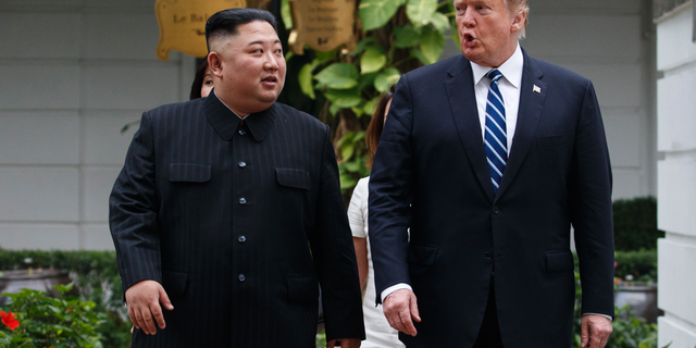 FILE: President Donald Trump and North Korean leader Kim Jong Un take a walk after their first meeting at the Sofitel Legend Metropole Hanoi hotel, in Hanoi. 