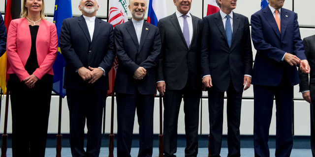 FILE - In this July 14, 2015 file photo, from left to right: European Union High Representative Federica Mogherini, Iranian Foreign Minister Mohammad Javad Zarif, Head of the Iranian Atomic Energy Organization Ali Akbar Salehi, Russian Foreign Minister Sergey Lavrov, British Foreign Secretary Philip Hammond and U.S. Secretary of State John Kerry pose for a group picture at the United Nations building in Vienna, Austria. Iran threatened Wednesday, May 8, 2019, to resume higher enrichment of uranium in 60 days if world powers fail to negotiate new terms for its 2015 nuclear deal, an agreement that capped over a decade of hostility between Tehran and the West over its atomic program. (Joe Klamar/Pool Photo via AP, File)