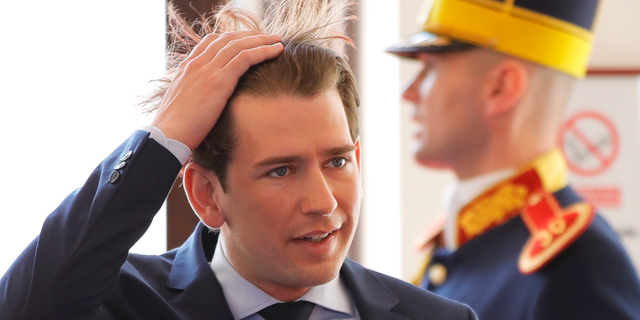 Austrian Chancellor Sebastian Kurz, left, fixes his hair as he arrives for an EU summit in Sibiu, Romania, Thursday, May 9, 2019. European Union leaders on Thursday start to set out a course for increased political cooperation in the wake of the impending departure of the United Kingdom from the bloc. (AP Photo/Vadim Ghirda)