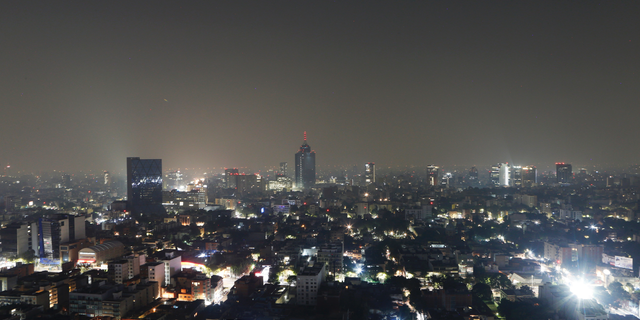 Smoke and pollution hangs over in Mexico City, early Thursday, May 16, 2019. Mexico City officials cancelled classes for millions of students for a second straight day as smoke from brush fires continued to choke the city. (AP Photo/Marco Ugarte)