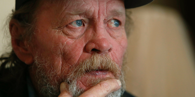 In this Friday, March 22, 2019 photo, Allan Votaw, 66, pauses as he recalls and describes the years of abuse he suffered at the Cal Farley's Boys Ranch during an interview at this home in Kingston, Okla. Votow says his childhood years of 1957-1967 at the famed ranch near Amarillo, Texas were marked with horrible abuses against himself, his two brothers and numerous other boys placed under care of the rural institution. (AP Photo/LM Otero)