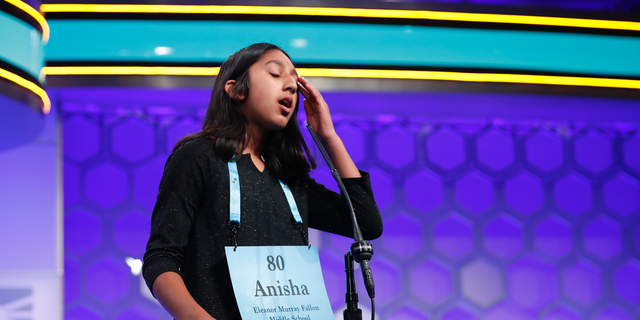 FILE - In this May 31, 2018 file photo, Anisha Rao, 12, from Dublin, Calif., reacts after spelling a word incorrectly during the evening finals of the Scripps National Spelling Bee in Oxon Hill, Md. An unremarkable sound can be the toughest thing for spellers to master at the Scripps National Spelling Bee. It's known as the schwa. It sounds like "Uh," and any vowel can make the sound. Spellers have a variety of techniques to figure out unfamiliar schwas, but none of the strategies is foolproof, and sometimes the only things to do are to memorize the word or guess. (AP Photo/Carolyn Kaster)