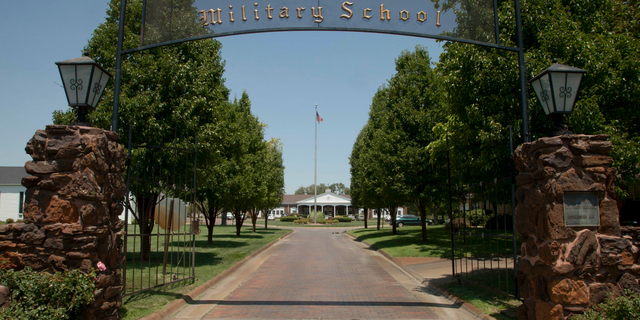 FILE - This June 27, 2012, file photo, shows the the entrance to St. John's Military Academy in Salina, Kan. Nearly seven months before publicly announcing its plans to close, the embattled Kansas military school amended its articles of incorporation to remove the Episcopalian church that founded it from receiving its property upon its demise. The Episcopalian boarding school announced in February it planned to shut down after its May 11 commencement. The 131-year-old school said education has changed dramatically, resulting in lower enrollment and unsustainable higher costs. (AP Photo/Orlin Wagner, File)
