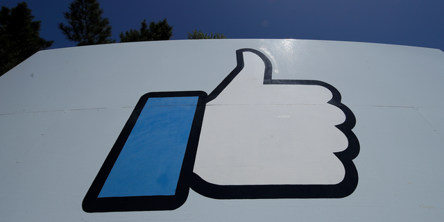 This April 25, 2019, photo shows the thumbs up Like logo on a sign at Facebook headquarters in Menlo Park, Calif.  (AP Photo/Jeff Chiu)