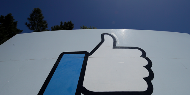 This April 25, 2019, photo shows the thumbs up Like logo on a sign at Facebook headquarters in Menlo Park, Calif.  (AP Photo/Jeff Chiu)