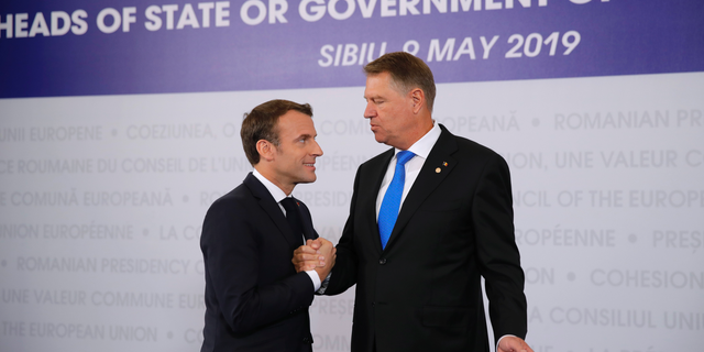 French President Emmanuel Macron, left, is welcomed by Romanian President Klaus Werner Ioannis as he arrives for an EU summit in Sibiu, Romania, Thursday, May 9, 2019. European Union leaders on Thursday start to set out a course for increased political cooperation in the wake of the impending departure of the United Kingdom from the bloc. (AP Photo/Vadim Ghirda)