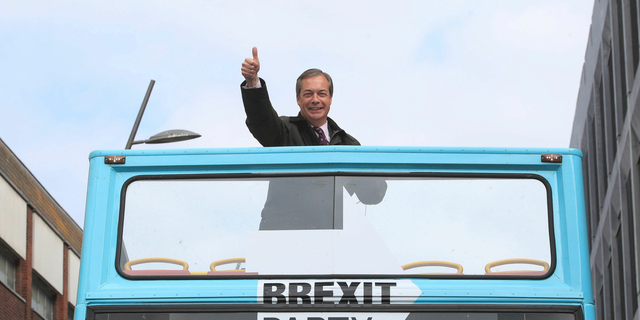 Brexit Party leader Nigel Farage gestures on an open-topped bus while on the European Election campaign trail in Sunderland, England, Saturday, May 11, 2019.