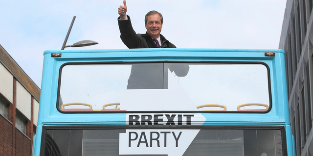 Brexit Party leader Nigel Farage gestures on an open-topped bus while on the European Election campaign trail in Sunderland, England, Saturday, May 11, 2019.